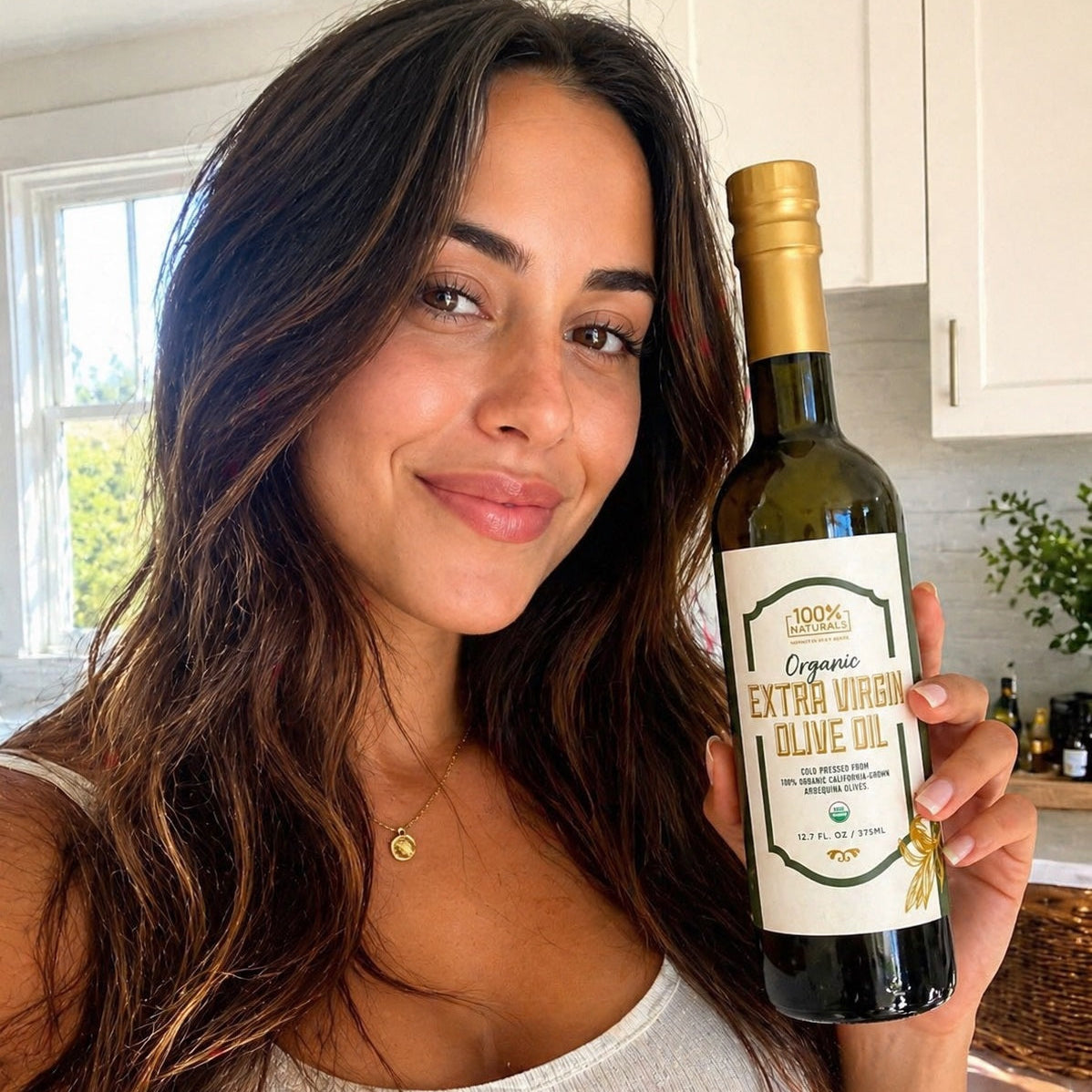 Woman holding a bottle of organic extra virgin olive oil in a kitchen setting